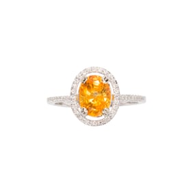 A yellow sapphire, diamond and 14k white gold ring