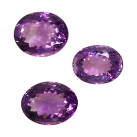 A group of three unmounted amethyst stones