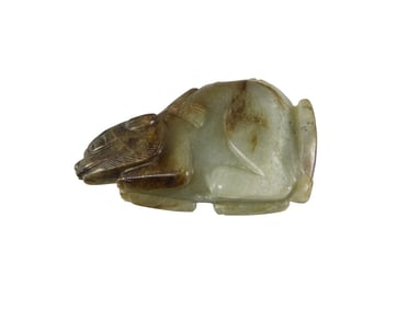 A Chinese mottled celadon jade beast toggle