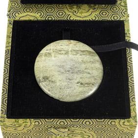 A Chinese chicken bone jade mirror