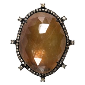 An orange sapphire, diamond,18k gold and silver ring