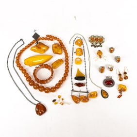 A lot of amber jewelry, including pearl shaped necklace, several amber pins, amber bracelet, metal