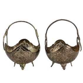 A pair of Persian pierced silvered footed baskets