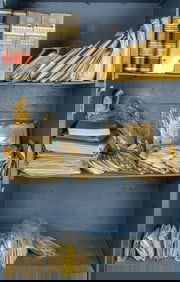 Three shelves with canceled Stamps on letters, loose stamps and several sparsely filled stamp albums