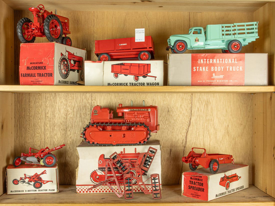 A group of vintage mainly McCormick miniature toy farm equipment with boxes (1 of 1)