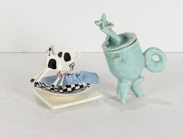A Studio ceramic teapot and a cow on a saucer