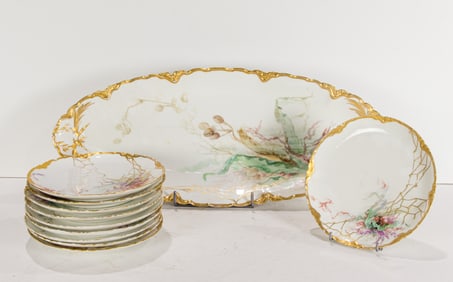 A Haviland & Co porcelain hand painted fish service, each decorated with aquatic plants, comprising