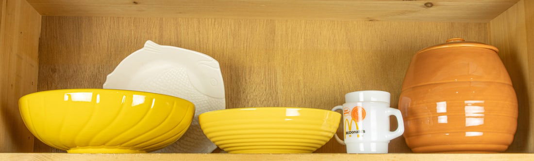 An assembled group including Bauer pottery: An assembled group of Bauer pottery, including ribbed bowl; cookie jar, 8.5"h and 'Chicken of the Sea' tuna plate, 10"l, together with swirl molded bowl and (2) vintage McDonalds coffee mugs [6 total]