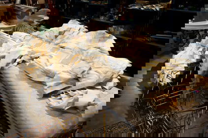 A plaid taffeta valance and three ivory silk drapes from a Mario Buetta designed interior