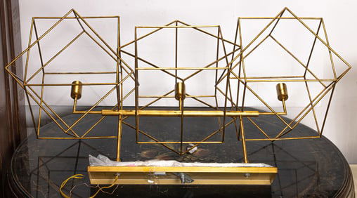 A Currey & Co Cubist gilt metal three light chandelier