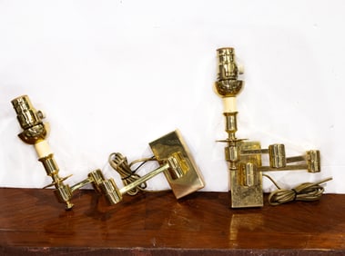 A pair of lacquered brass swing arm wall lights