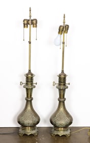 A pair of Islamic style brass oil lamps