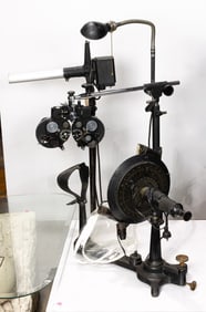 A group of antique and vintage optical equipment, including Bausch & Lomb ophthalmic testing device
