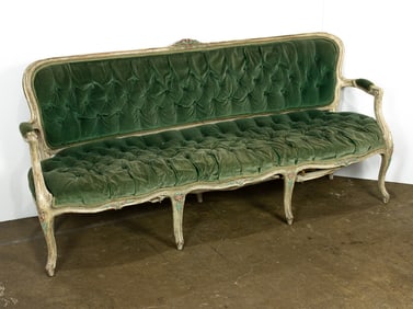 A French Provincial limed sofa with tufted green velvet upholstery