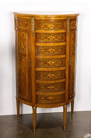 A Louis XVI style bronze mounted and marquetry inlaid demilune chest of drawers