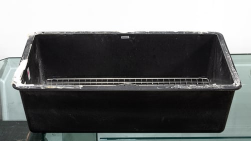 A Blanco black undermount kitchen sink with stainless drainage grid