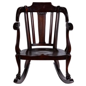 An Empire style mahogany rocking chair with animal claw feet