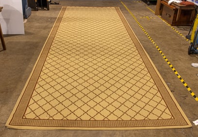 A large machine made rug in a trellis pattern