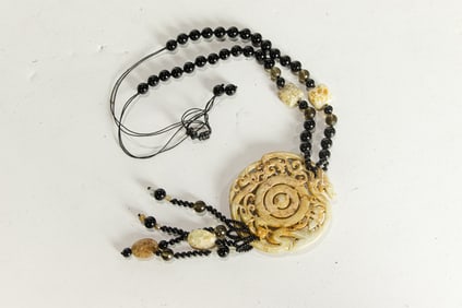 A Chinese russet carved jade pendant