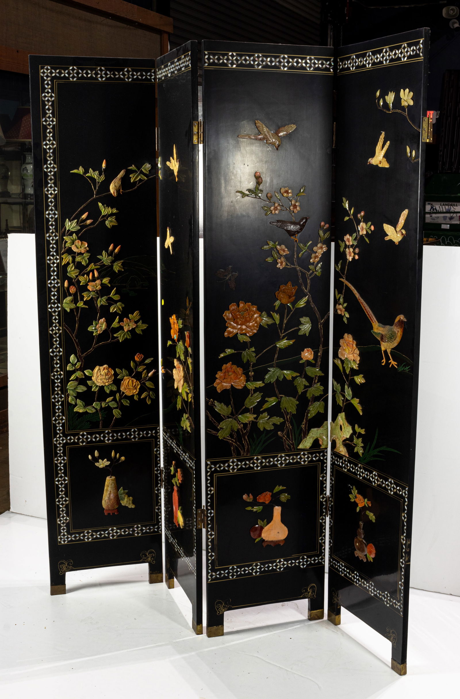 A Chinese black lacquered mother of pearl and hardstone inlaid six-panel folding screen (1 of 2)