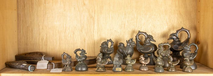 A shelf of Burmese bronze weights and scales