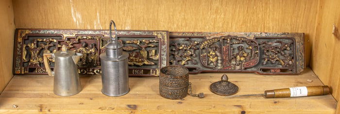 A shelf of Asian decorative items