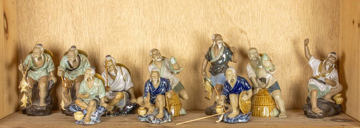A shelf of Chinese ceramic fisherman figures