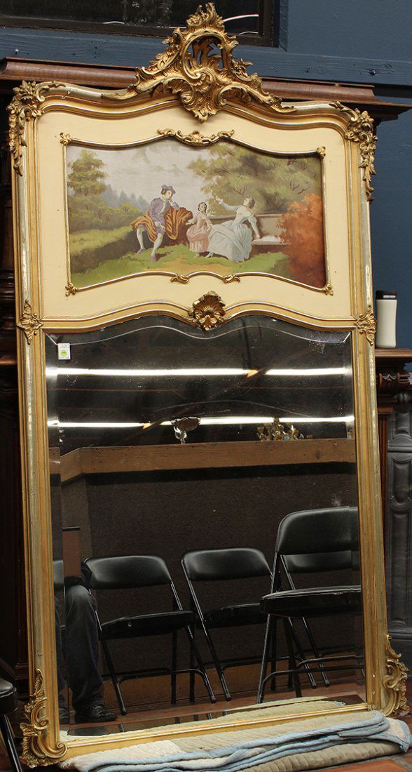 French Louis XV style giltwood carved trumeau mir: French Louis XV style giltwood carved trumeau mirror, the rocaille carved crest above an oil on canvas depicting a courting scene, above the bevelled looking glass and framed in a burnished gilt moldi