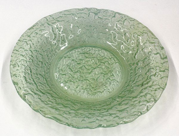 Glen Lukens glass group: (lot of 10) Glen Lukens glass charger and plates, the molded glass form executed in mottled green and rising on a circular footed base signed Glen Lukens, 11.25""w, together with nine textured glass p