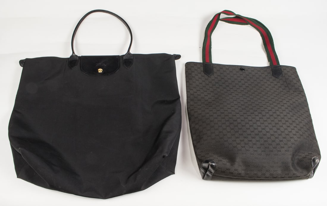 Two vintage black tote bags including Gucci and Longchamps: Two vintage black tote bags, the first Gucci monogramed Supreme coated canvas with fabric handle, approximately 15.5"h x 15"w; the second Longchamps Les Pilage tote bag, approximately 16"h x 19"w