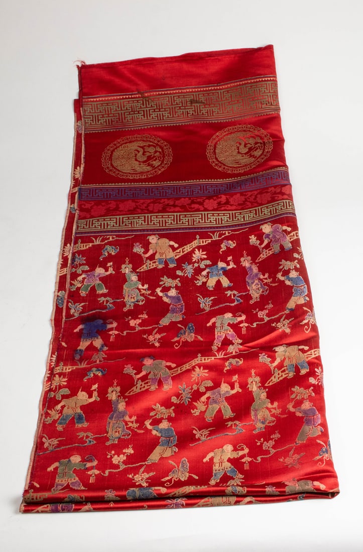 A Chinese red brocade 'hundred children' hanging panel (1 of 1)