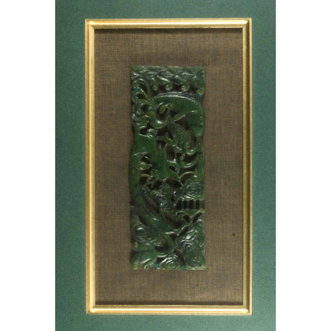 A Chinese spinach jade plaque: A Chinese spinach jade plaque. Decorated with carp jumps over the dragon gate, framed and glazed, 2.25"h x 6.25"w.