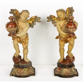 A pair of Continental Baroque polychrome figures of putti