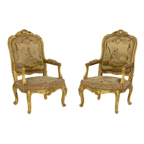 A pair of French Louis XV style giltwood carved fauteuils circa 1860