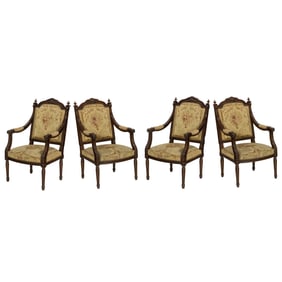 A suite of four Napoleon III tapestry upholstered carved wood armchairs