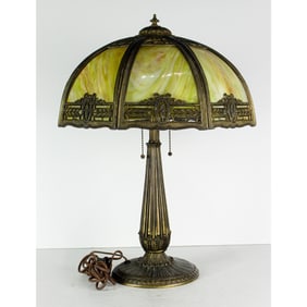 An Arts & Crafts leaded glass panel and patinated metal lamp