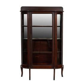 An Arts & Crafts bow front china cabinet