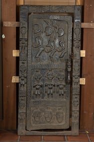 An African Dogon carved wood figural door