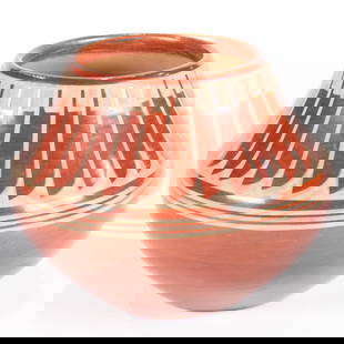 A Maria Martinez and Popovi Da San Ildefonso redware jar: A Maria Martinez and Popovi Da San Ildefonso redware jar, designed with a buff feather collar around the upper third, signed on the underside, Maria / Popovi, 5.5"h x 7"w