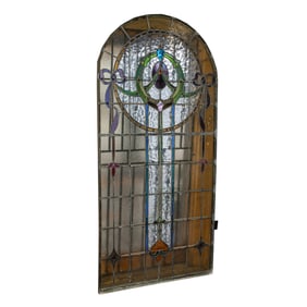 A large Continental arched leaded glass window panel