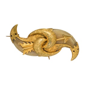 A tiger tooth and high karat gold brooch