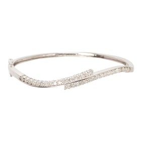 A 14k white gold and diamond bangle