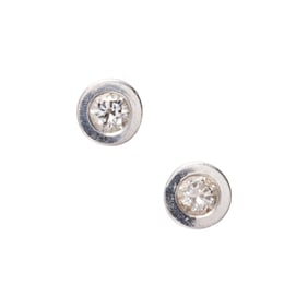A pair of diamond and 14k white gold stud earrings