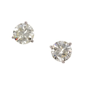 A pair of diamond and 14k white gold stud earrings