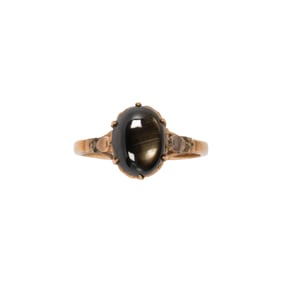 A black star sapphire and 14k gold ring