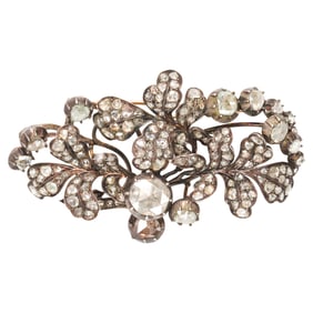 An antique diamond and silver-topped 14k gold brooch