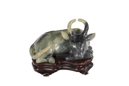 A Chinese black and white jade buffalo figure