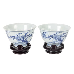 A pair of Chinese blue and white tea cups with stands