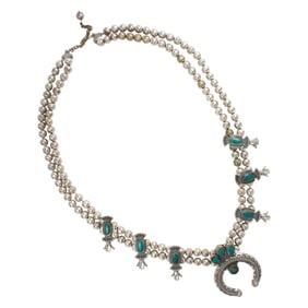 A turquoise and silver squash blossom necklace