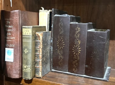 A collection of leather bound books, including The Philatelic History of The United States Westport